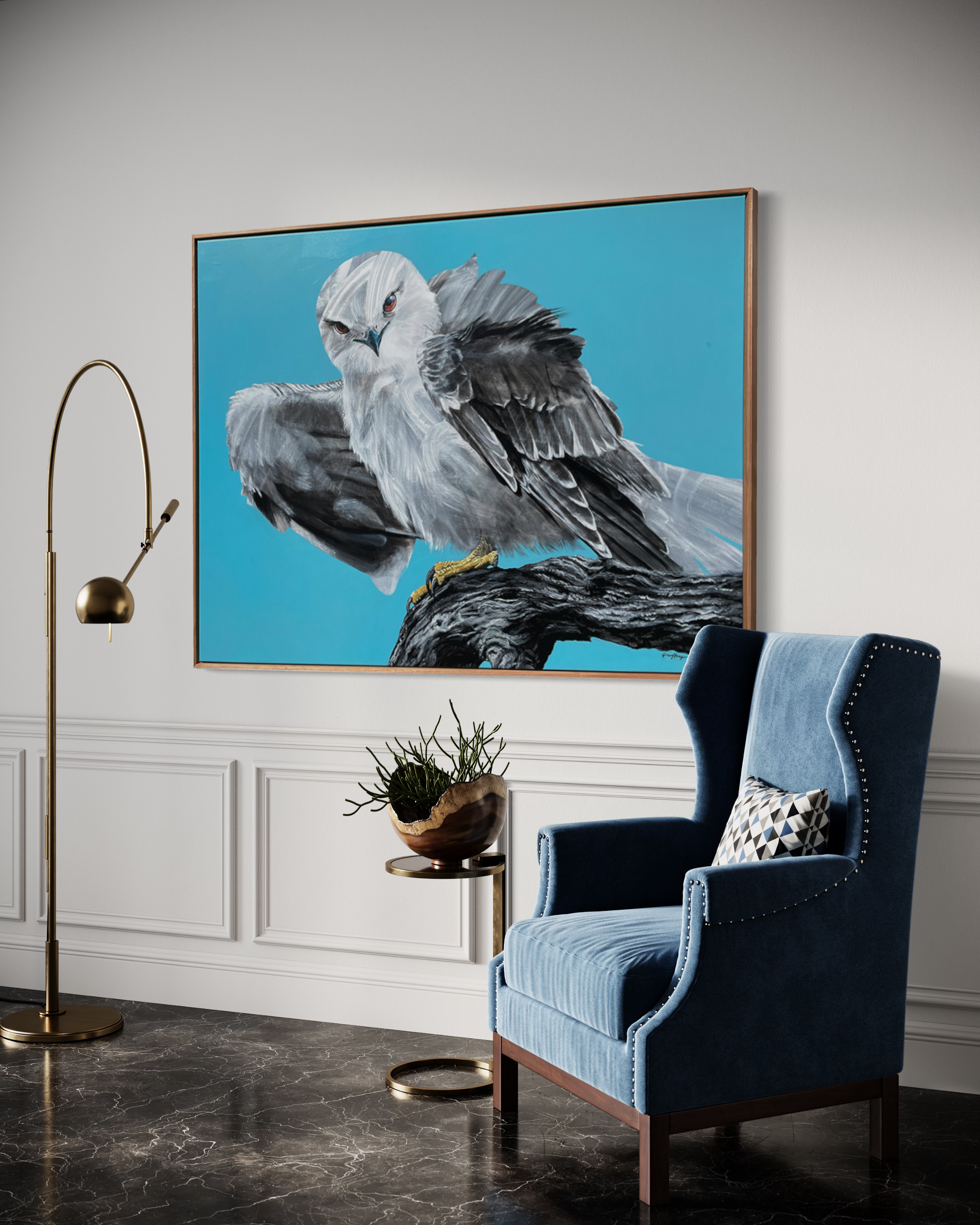 Photo of Geoffrey Carran's Painting of a Black Shouldered Kite hanging on the wall behind stylish furniture, an occasional chair and modern freestanding lamp